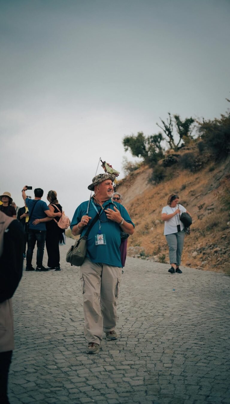 Group of tourists walking on a cobblestone road in Adıyaman, Turkey. Scenic travel experience.